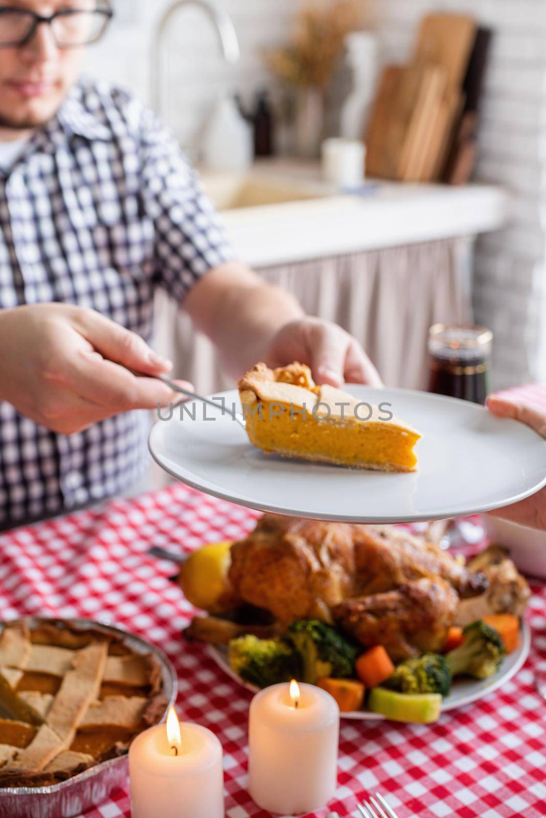 woman and man eating thanksgiving dinner at home kitchen by Desperada
