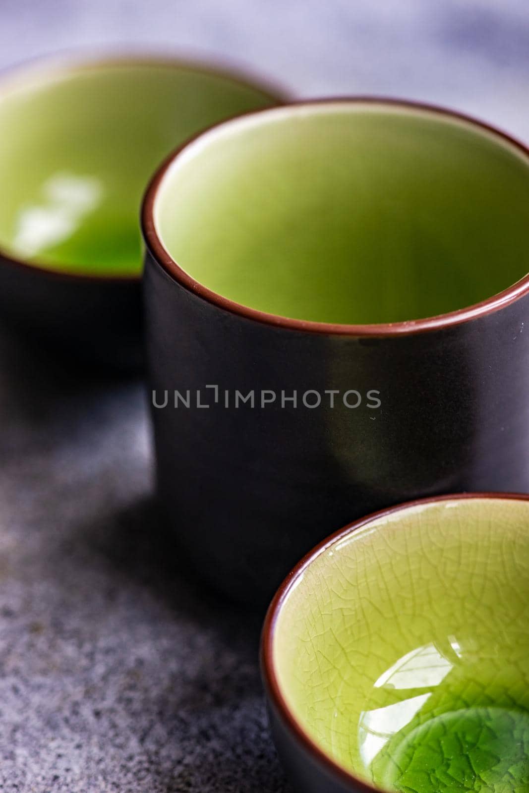 Round geometric green ceramic shapes on concrete background