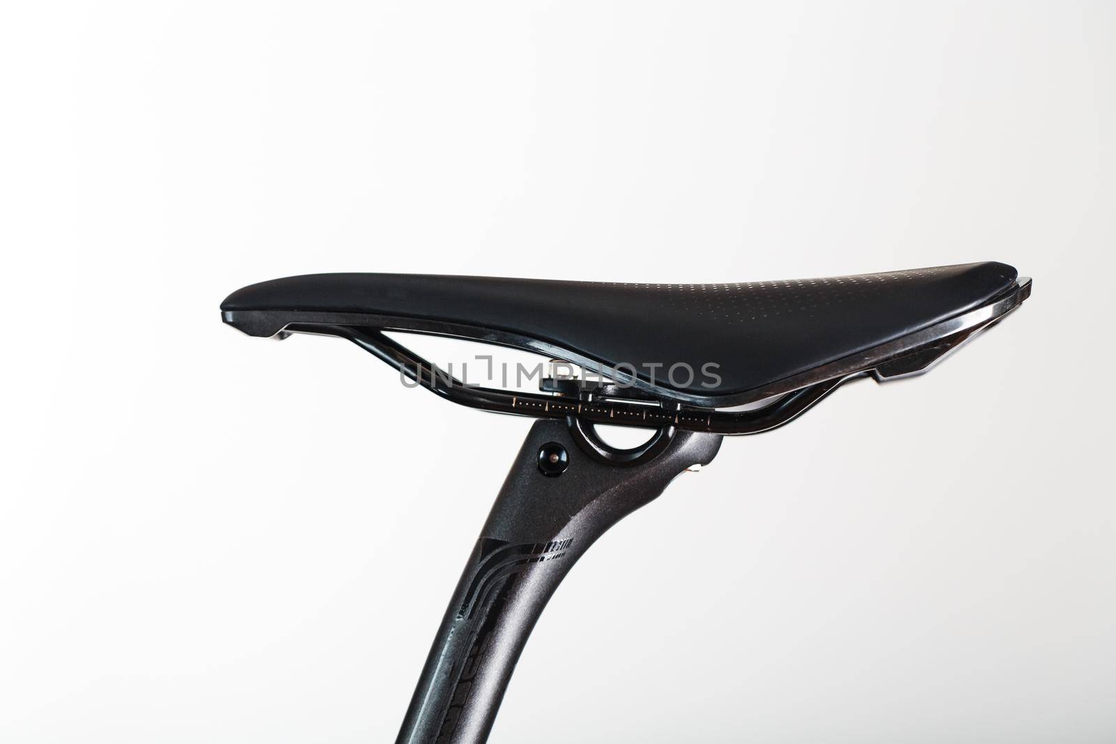 Bicycle saddle with seatpost on a light background accessories for bike repair and tuning