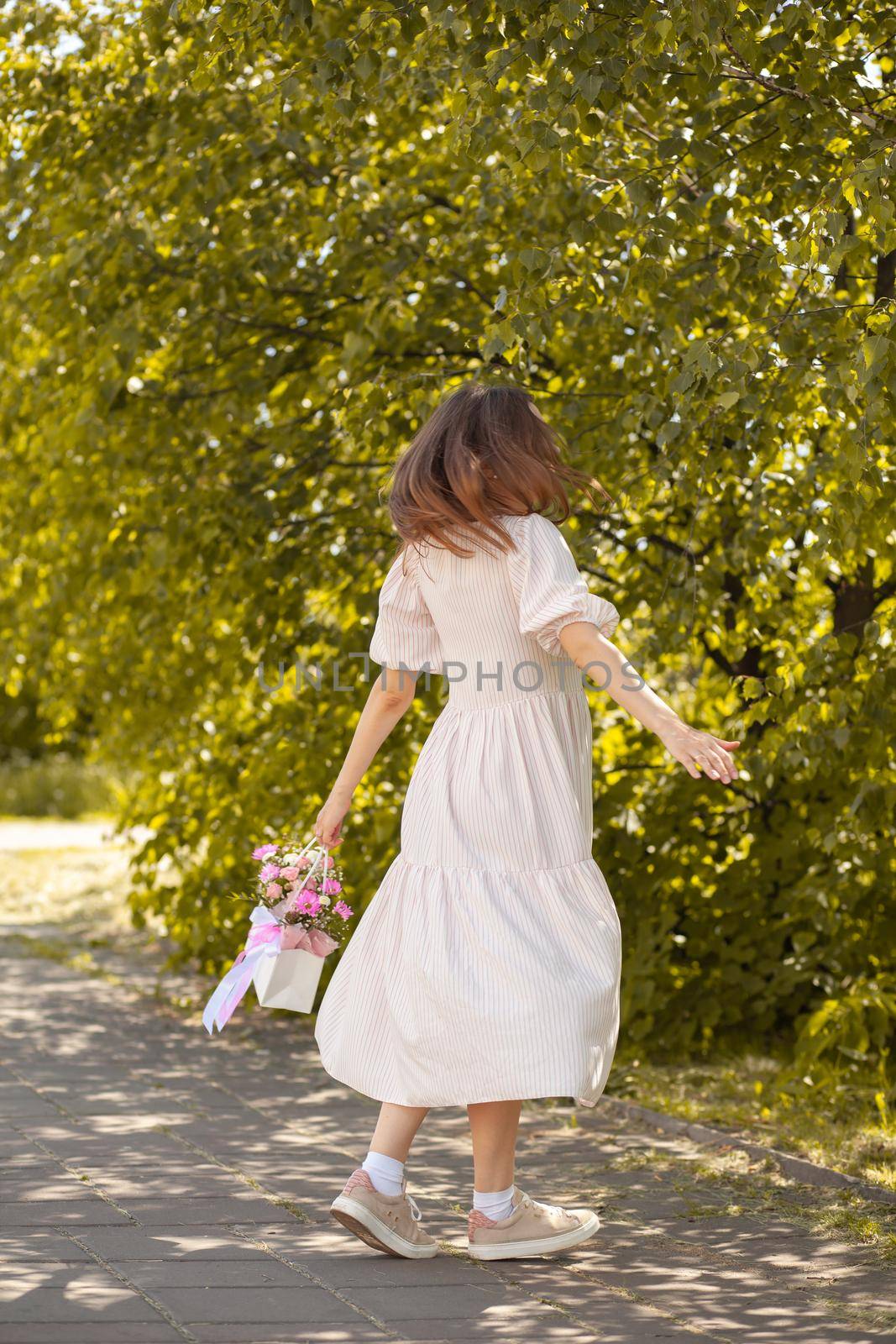 A beautiful bouquet of flowers in a box in the hands of a girl by AnatoliiFoto