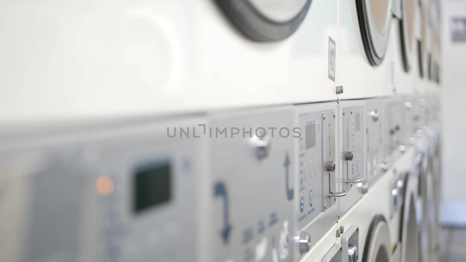 Washing machines, public coin laundry, USA. Self-service laundromat, laundrette. by DogoraSun