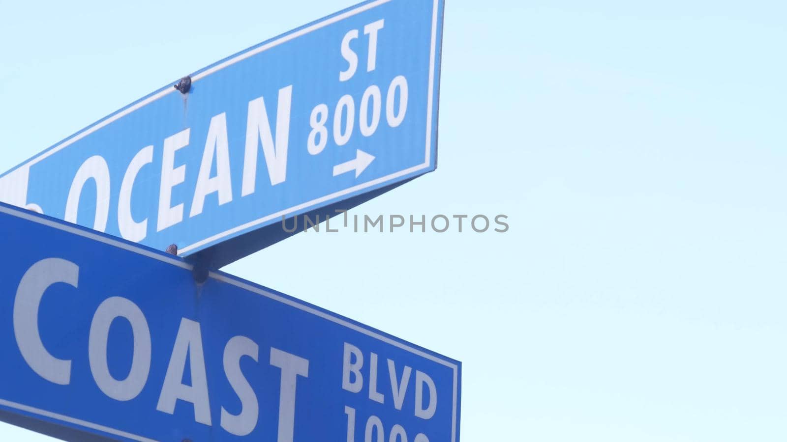 Coast and Ocean street road sign, California city USA. Tourist vacations resort. by DogoraSun