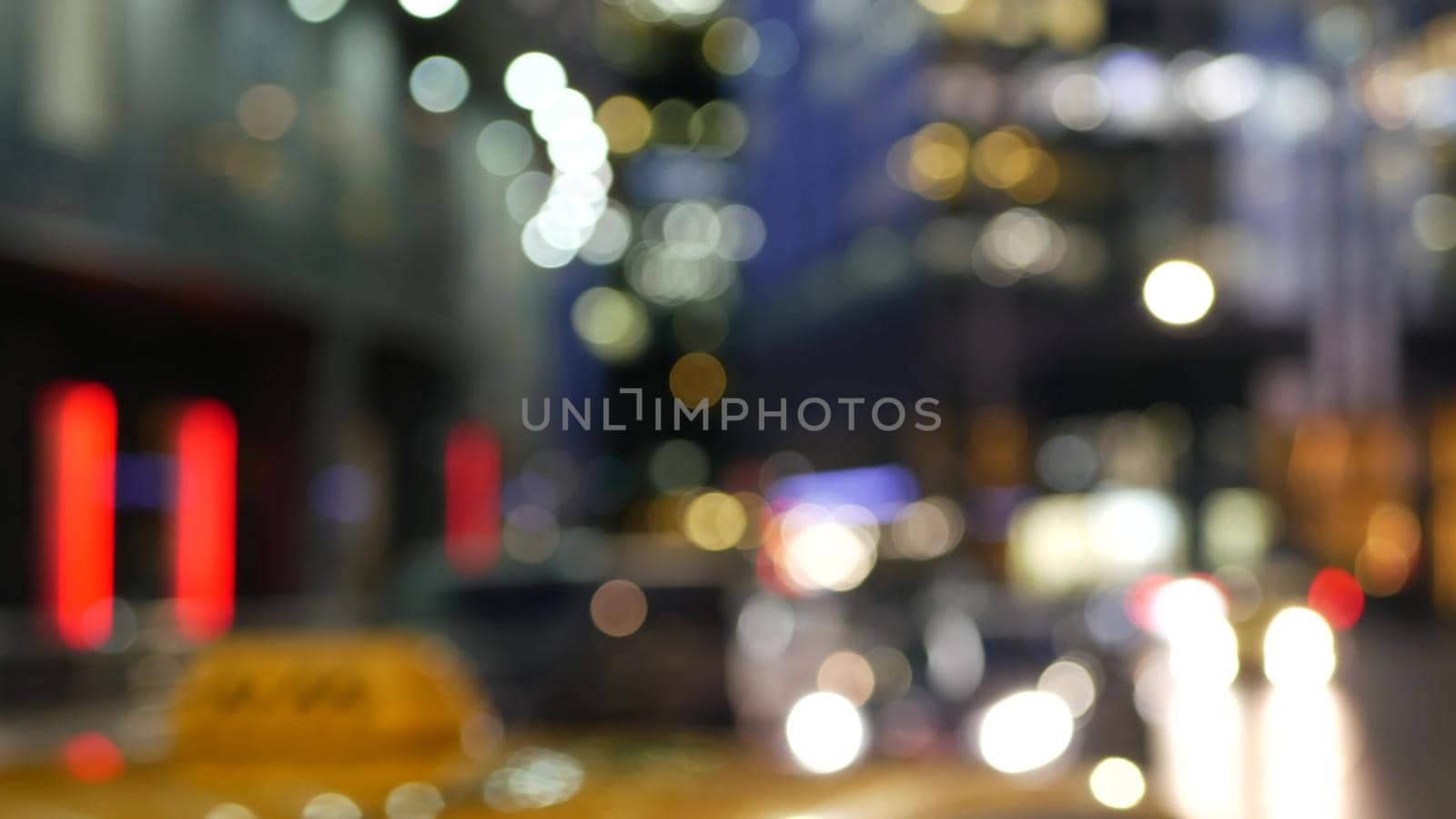 Car lights on road, traffic on street. Urban downtown city life. Yellow taxi cab by DogoraSun