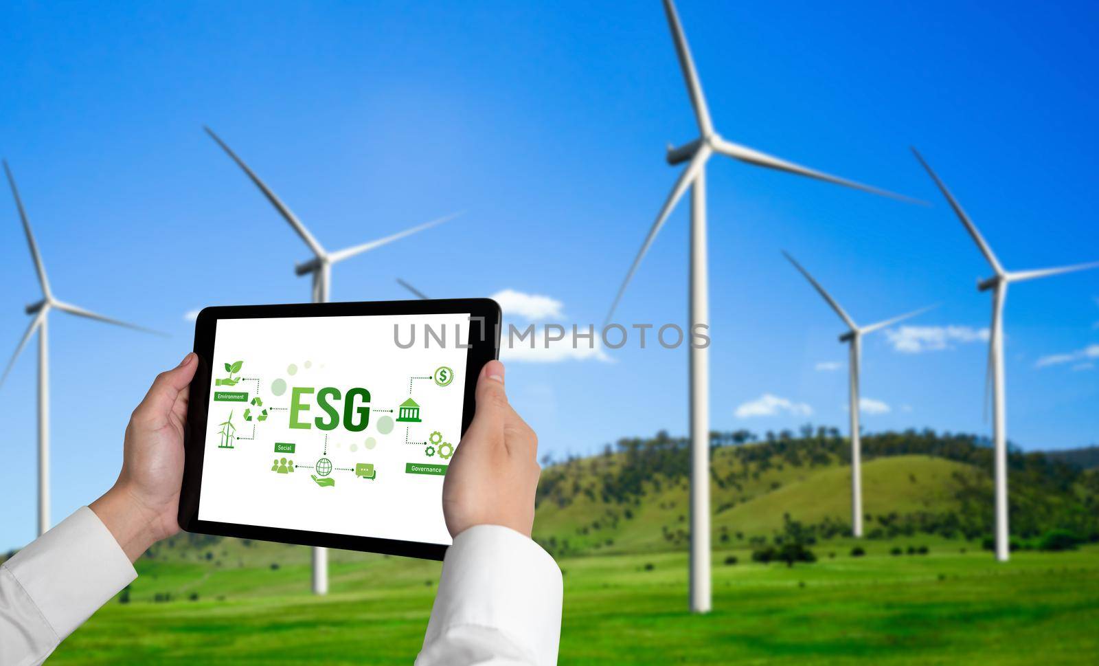 Green business transformation for environment saving and ESG business concept. Businessman using tablet to set corporate goal toward environmental friendly management and alternative clean energy use.