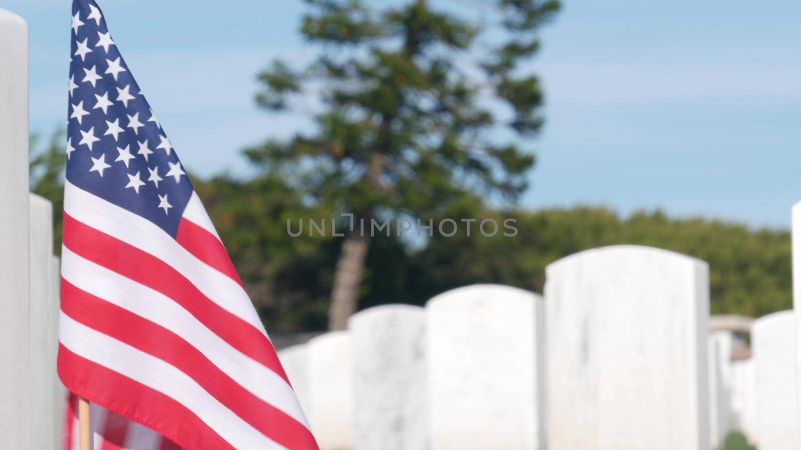 Tombstones and american flag, national military memorial cemetery in USA. by DogoraSun