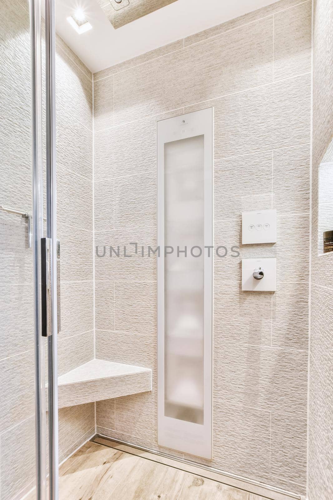 Sink base cabinet and mirror cabinet in white tiled bathroom with wall hung toilet