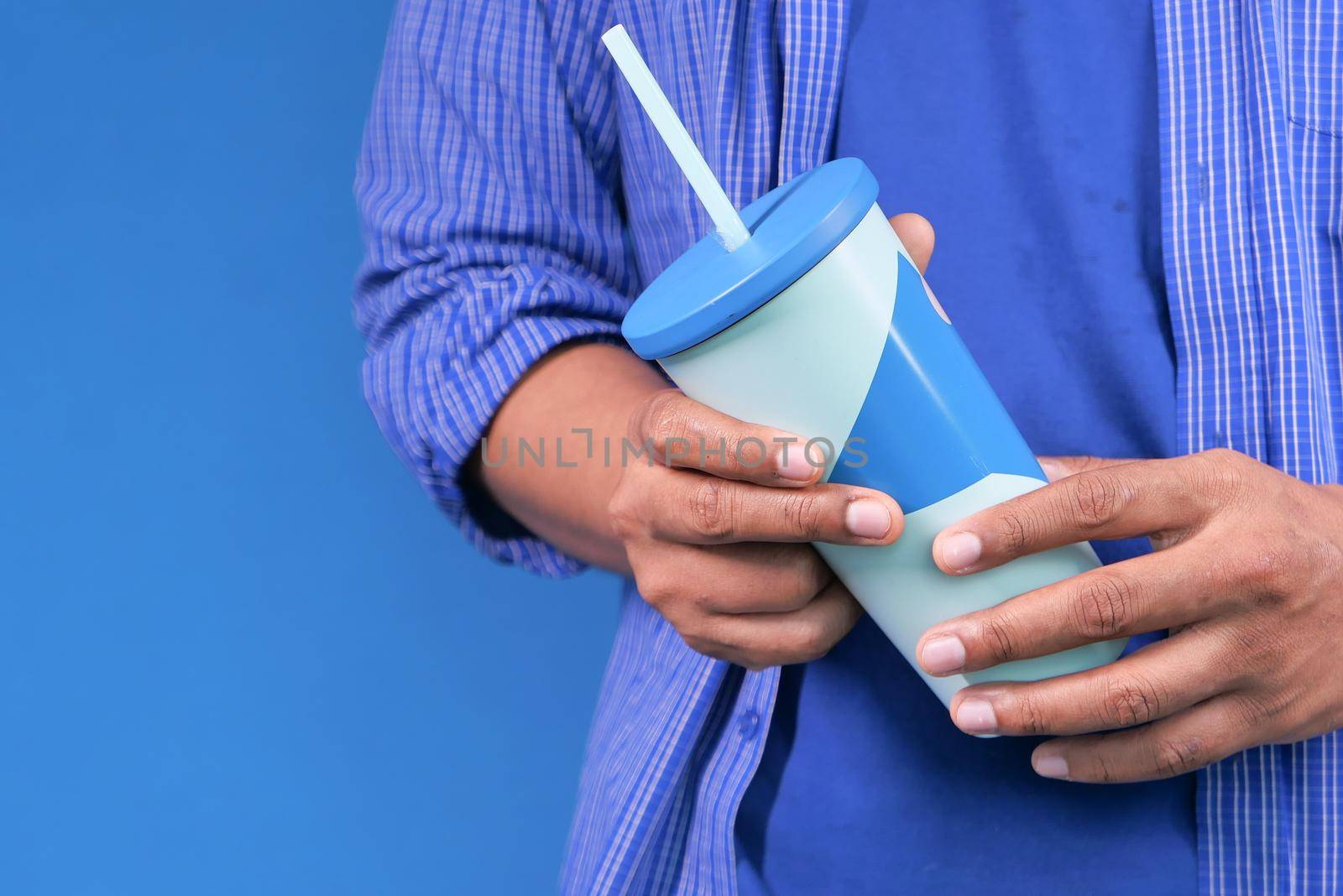 hand holding reusable eco coffee cup close up .