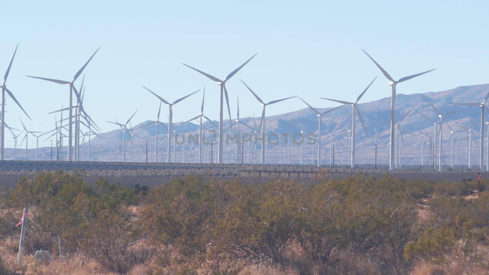 Windmills on wind farm, wind mill energy generators. Desert windfarm, USA. by DogoraSun