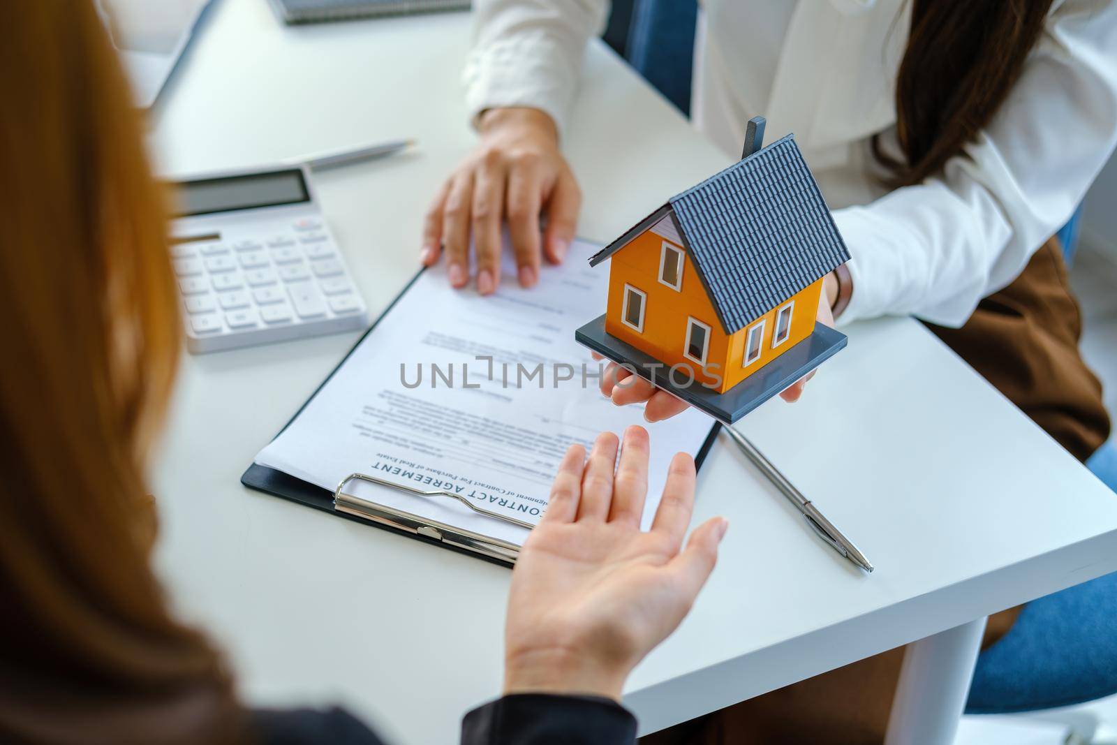 Guarantee, mortgage, agreement, contract, sign, real estate agent delivers the house to the customer after signing important contract documents.