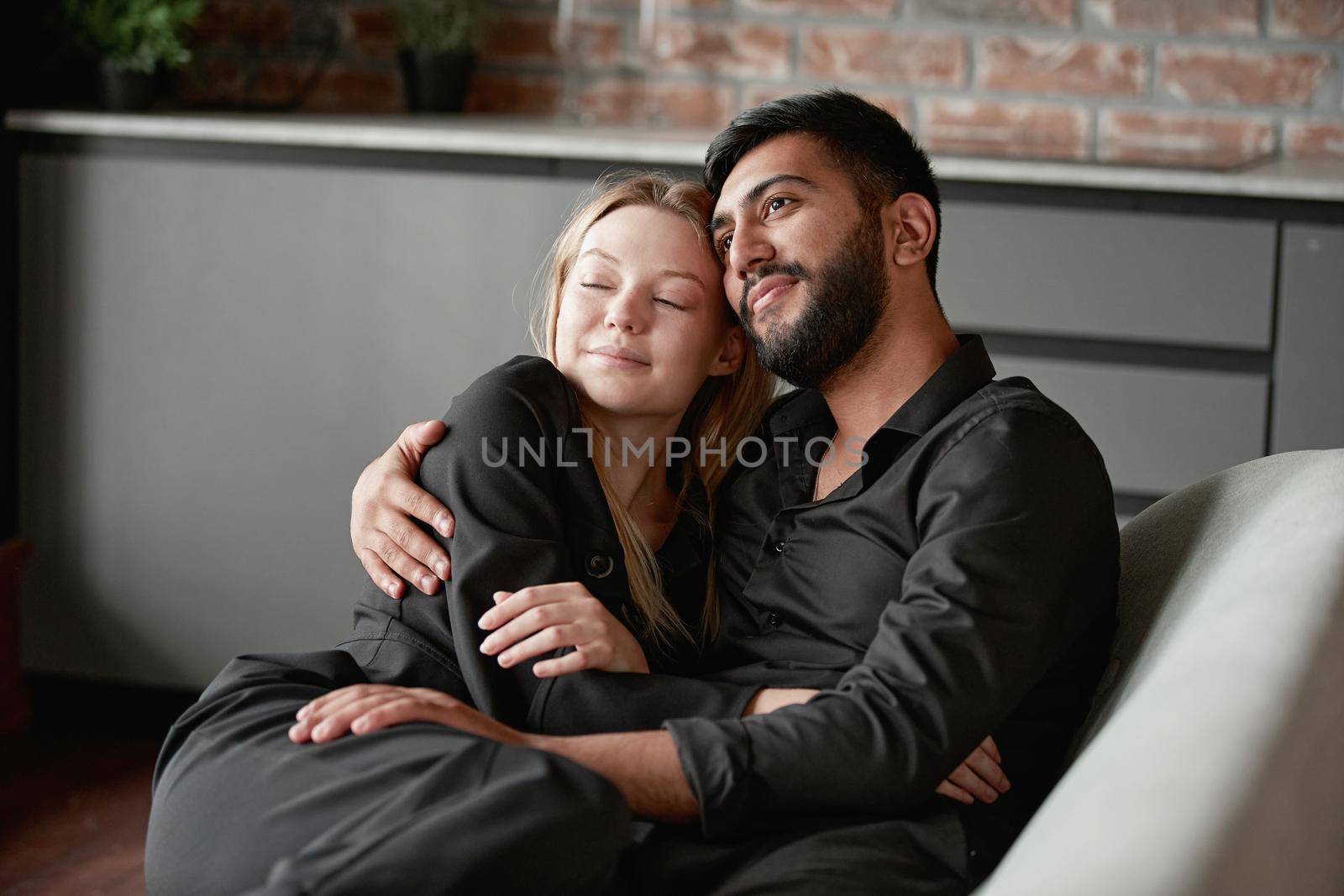 loving husband and wife dream sitting on the couch. by SmartPhotoLab