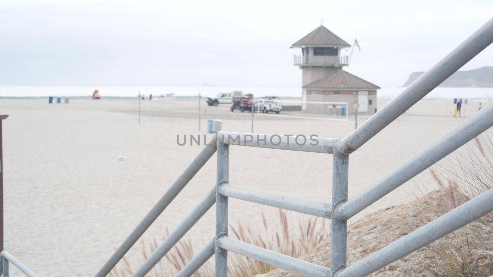 Lifeguard stand or life guard tower hut, surfing safety on California beach, USA. Rescue station, coast lifesavers wachtower or house, Coronado ocean beach, San Diego. Beach access stairs or steps.