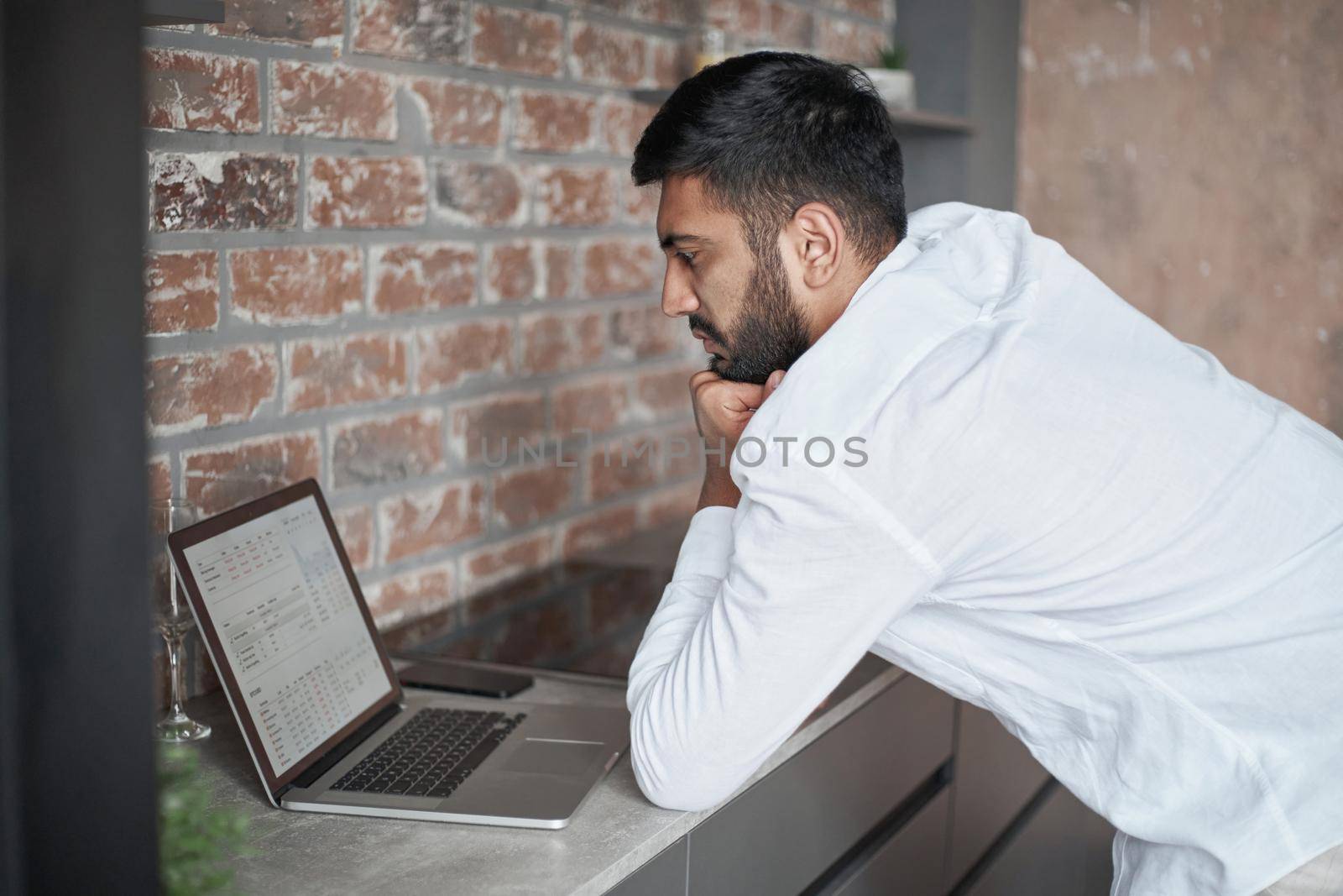 young man using a laptop in the kitchen. close-up.