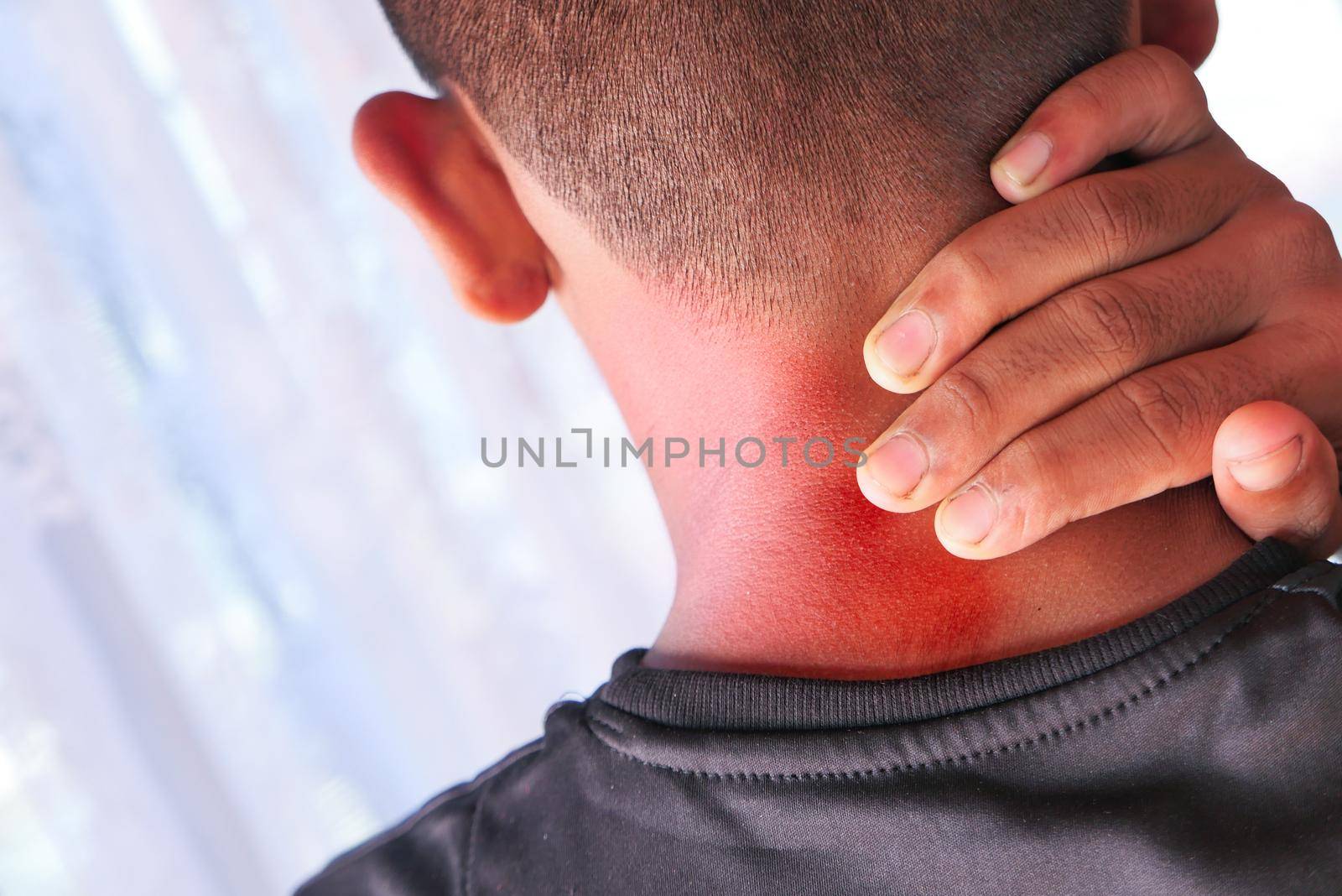 man suffering from neck or shoulder pain at home