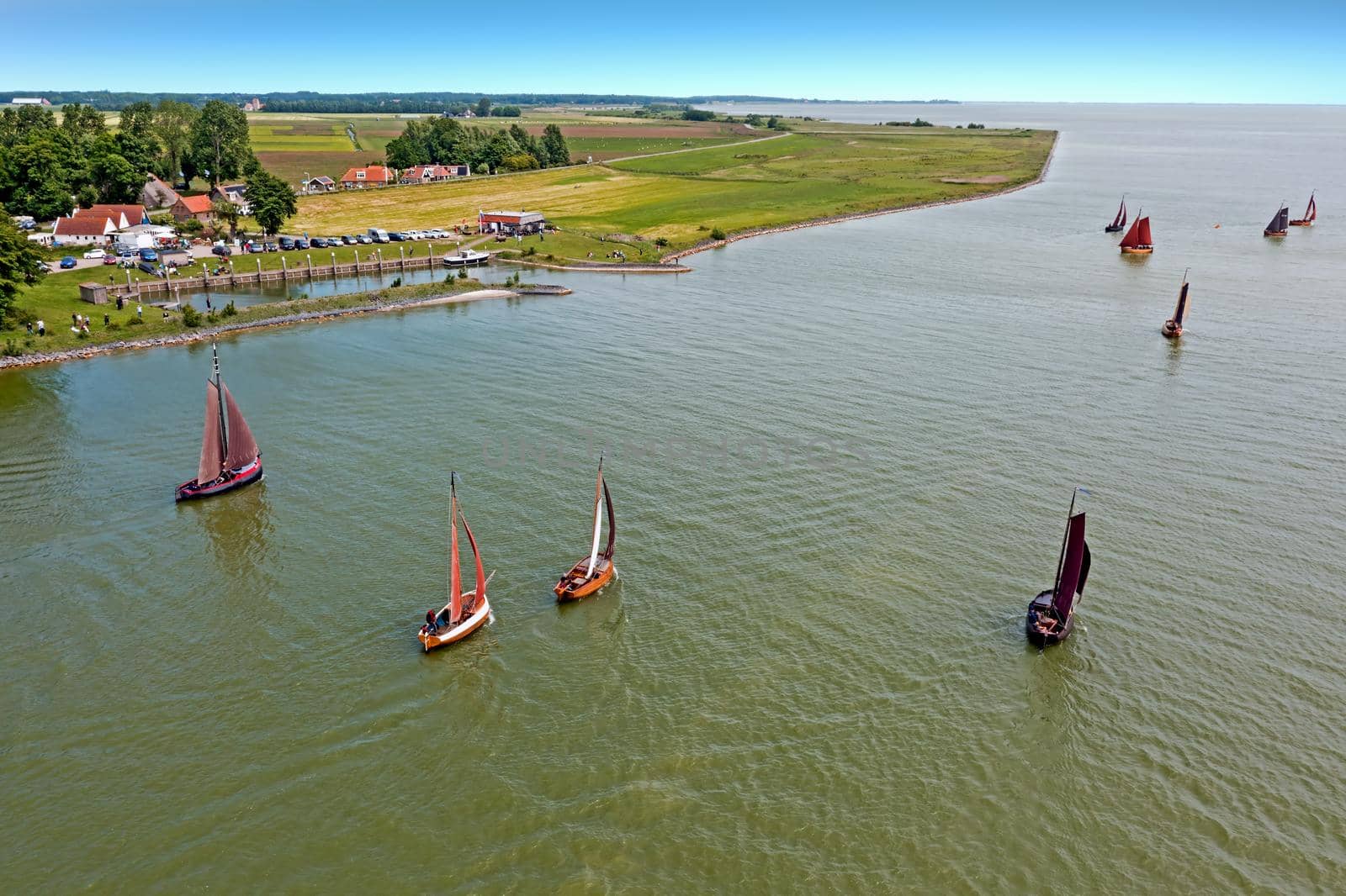 Aerial from traditional dutch wooden boats at the IJsselmeer near the harbor from Laaxum in the Netherlands by devy