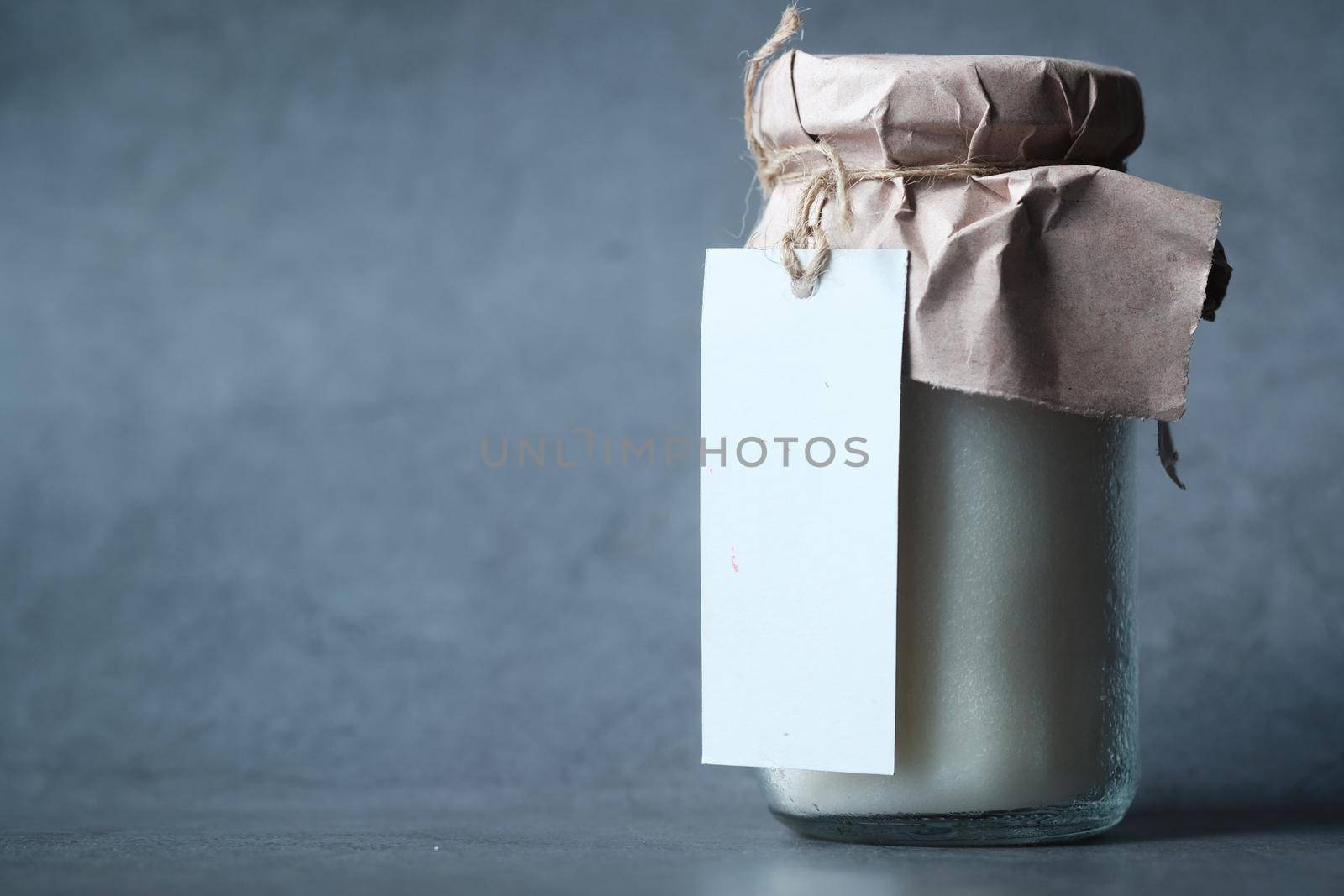 coconut oil in jar with a white label on black background..