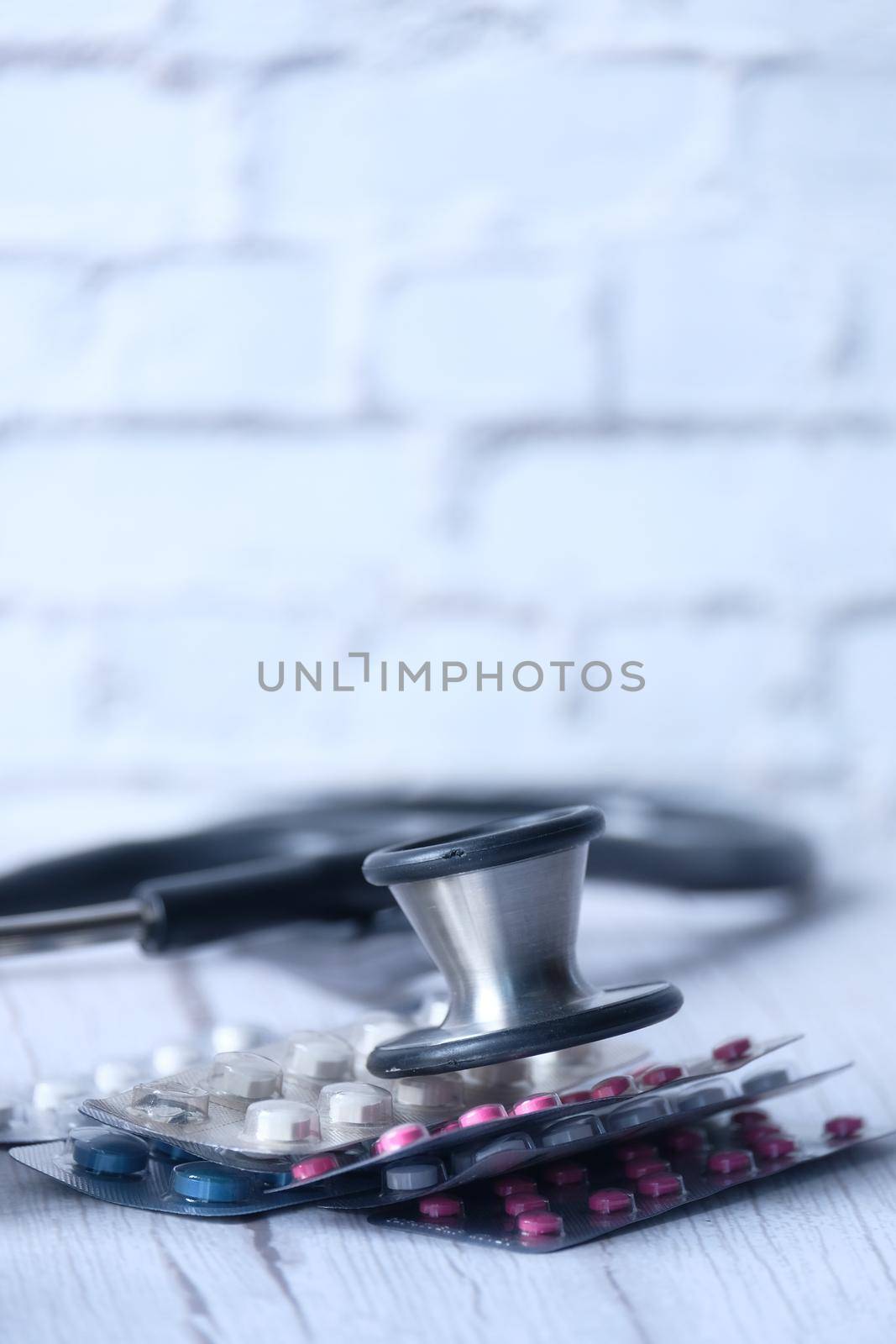 blister pack and stethoscope on white background ,