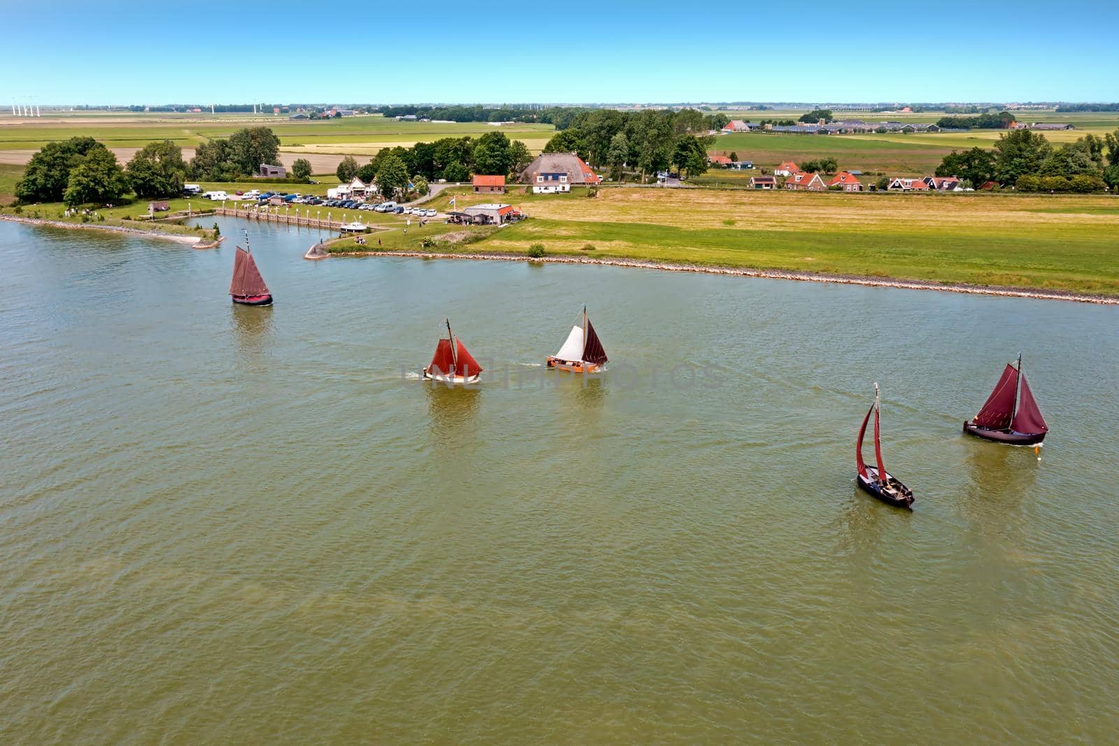 Aerial from traditional dutch wooden boats at the IJsselmeer near the harbor from Laaxum in the Netherlands by devy