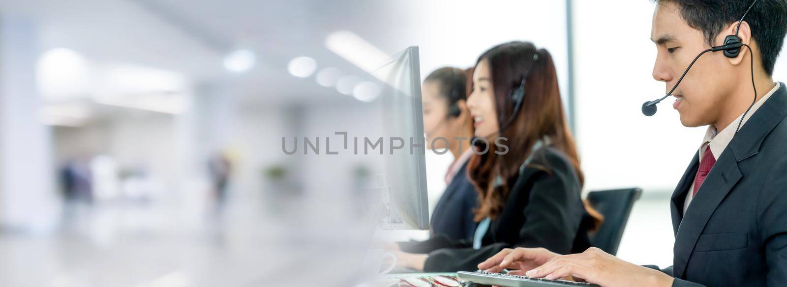 Business people wearing headset working in office in widen view to support remote customer or colleague. Call center, telemarketing, customer support agent provide service on telephone video call.