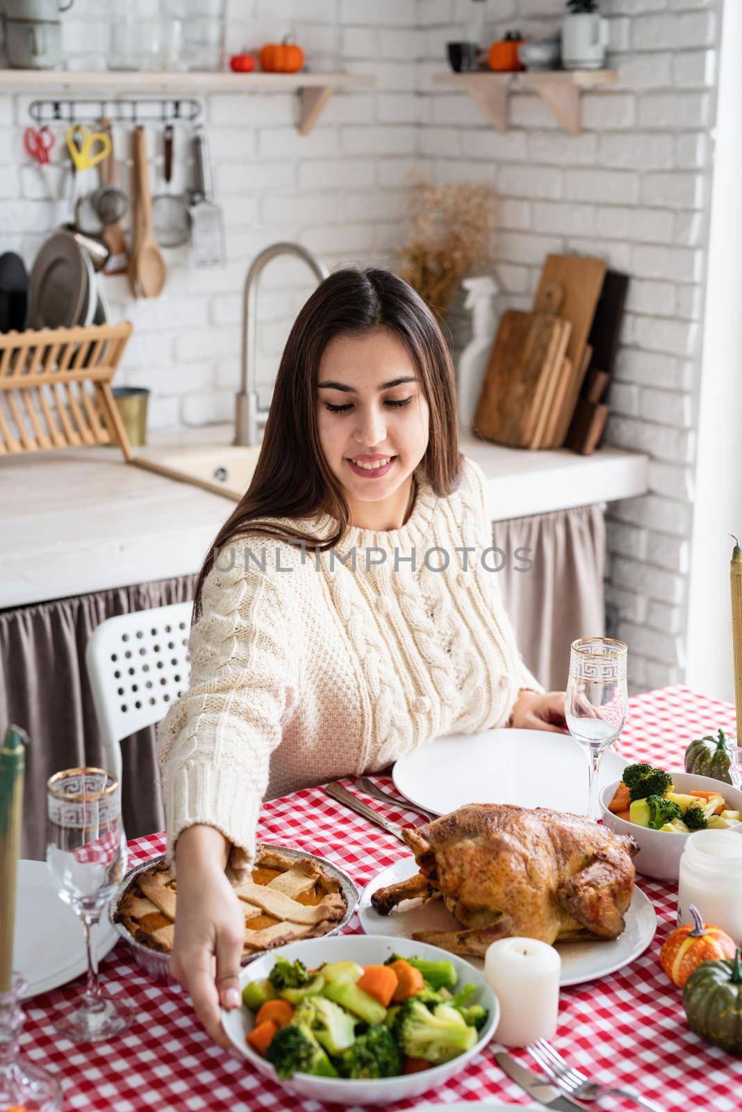 Happy Thanksgiving Day. Autumn feast. Woman celebrating holiday cooking traditional dinner at kitchen