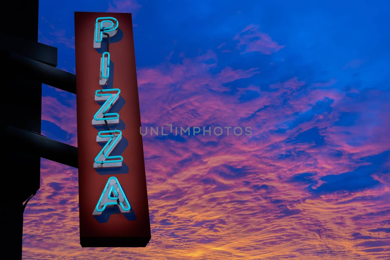 Retro Neon Pizza Sign At Sunset by mrdoomits