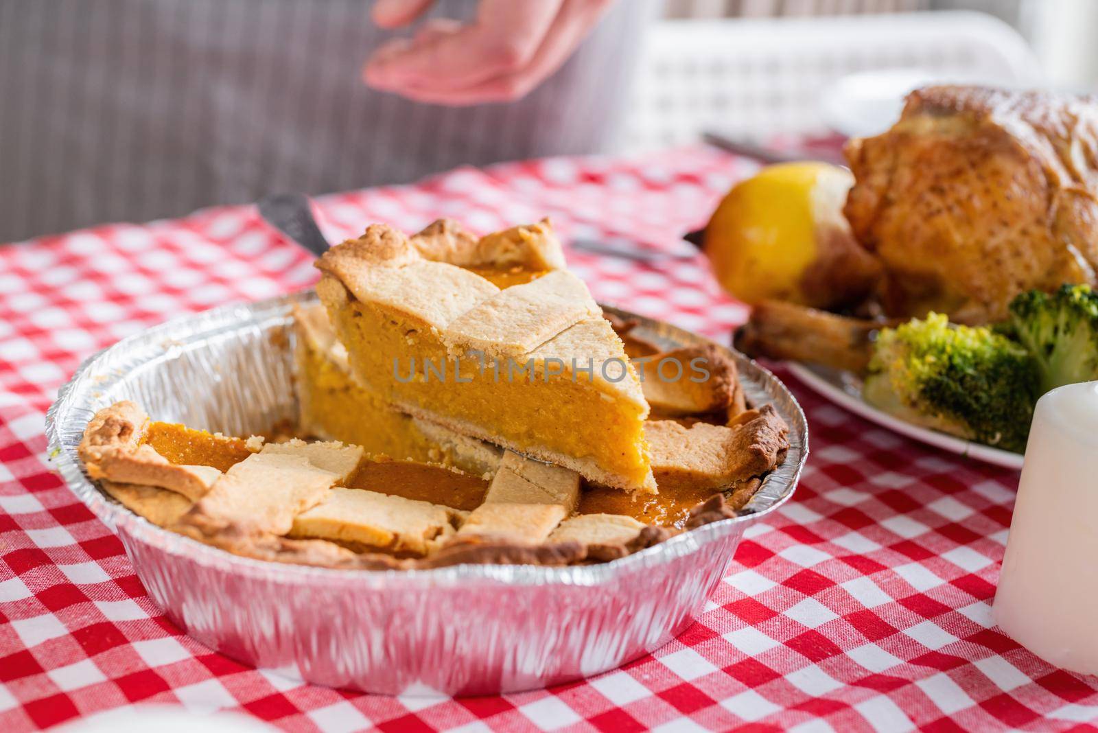 Happy Thanksgiving Day. Autumn feast. Woman celebrating holiday cooking traditional dinner at kitchen with turkey, vegetables and pumpkin pie. closeup pumpkin pie on table