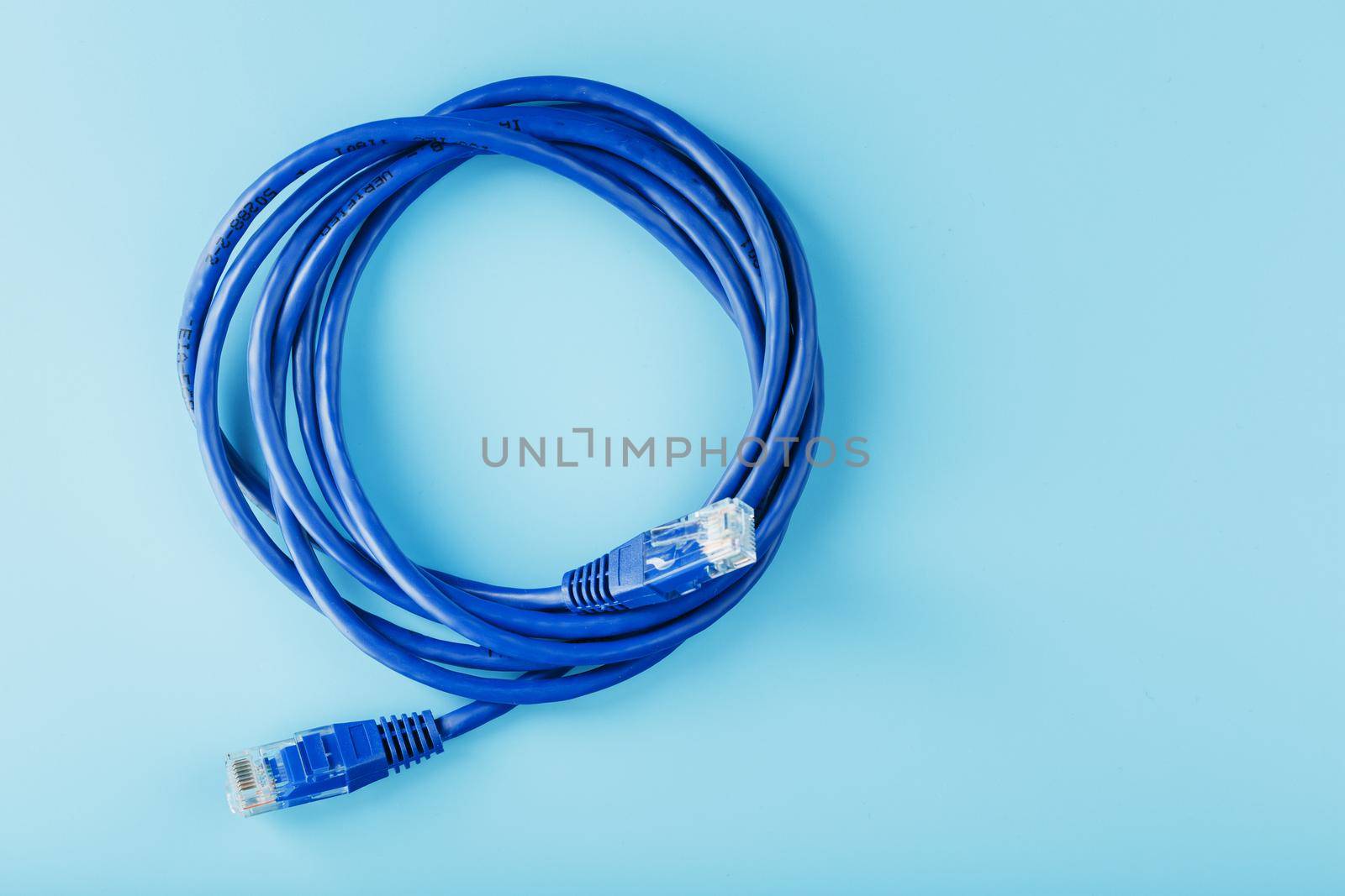 Blue UTP Internet Cable - Isolated on a blue background Ethernet Cord