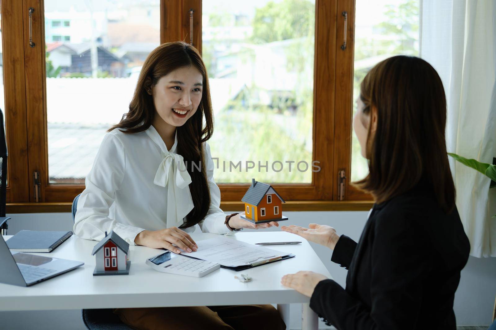 Guarantee, mortgage, agreement, contract, sign, real estate agent delivers the house to the customer after signing important contract documents by Manastrong