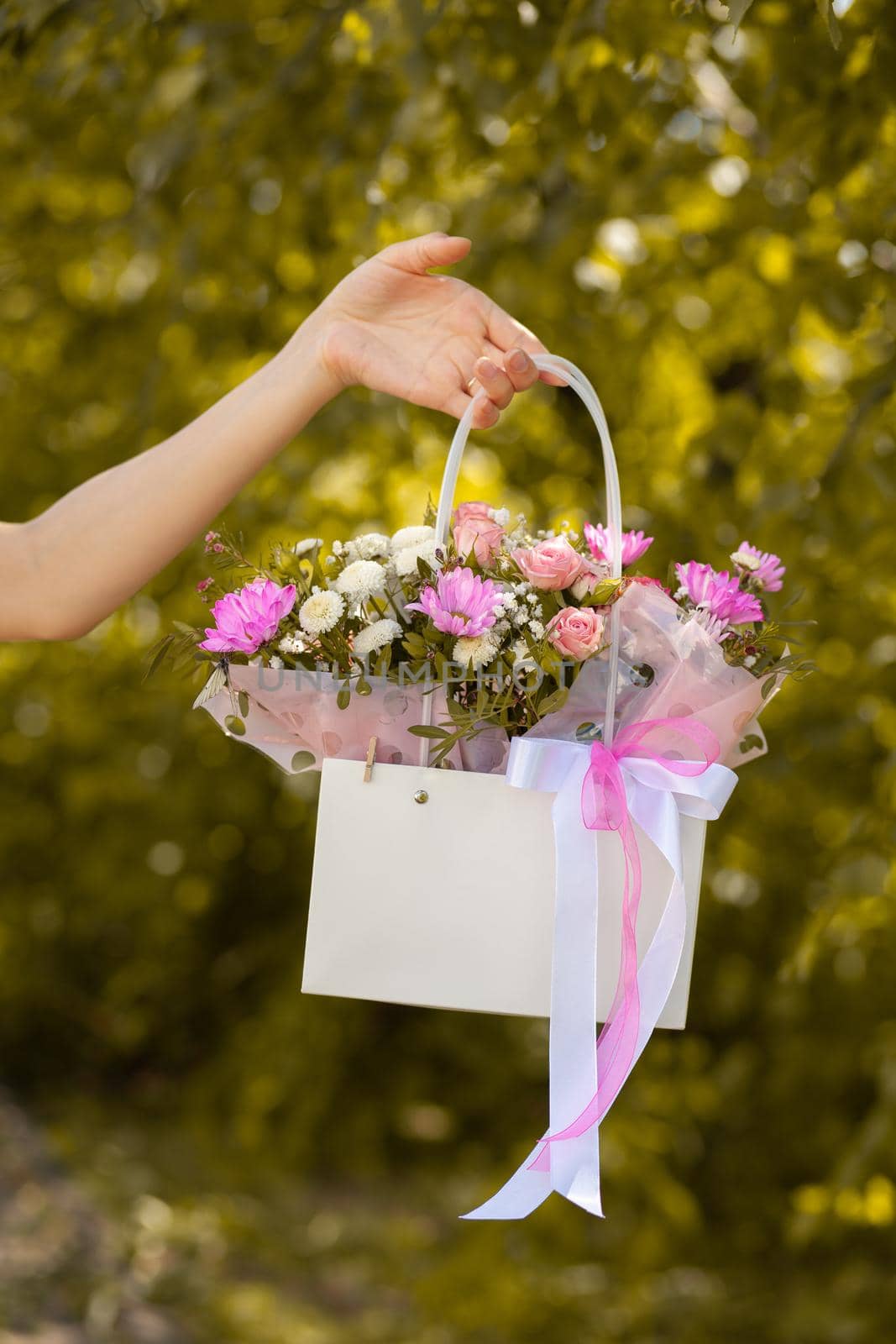 A beautiful bouquet of flowers in a box in the hands of a girl by AnatoliiFoto