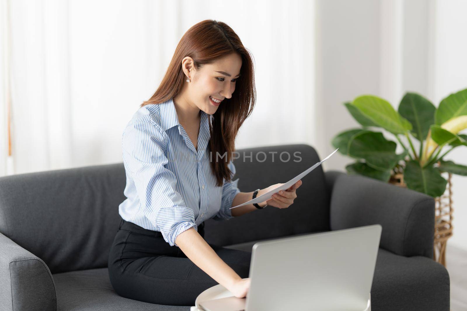 Charming Asian Business Woman working at office. Account and finance concept