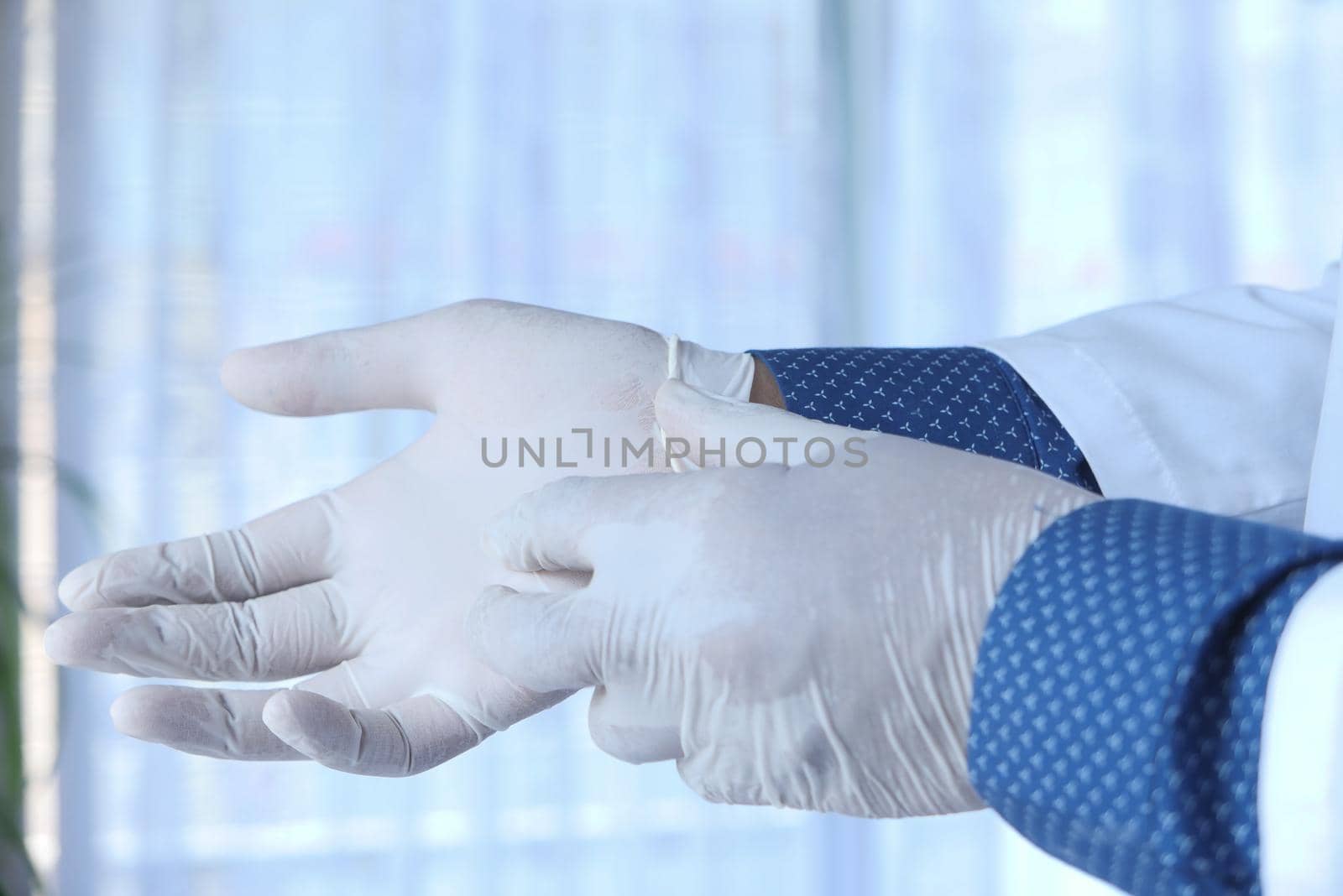 man doctor wears medical gloves.