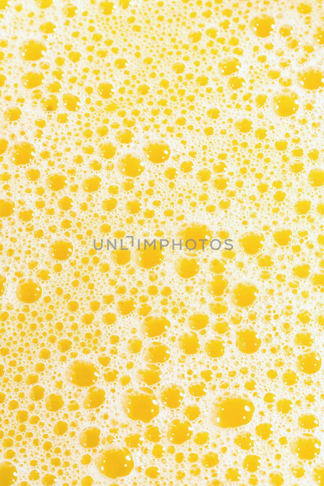 Closeup of splashing orange juice, top view. Splash of fresh sweet orange, mango, fruit juice. Freeze motion of pouring orange juice .