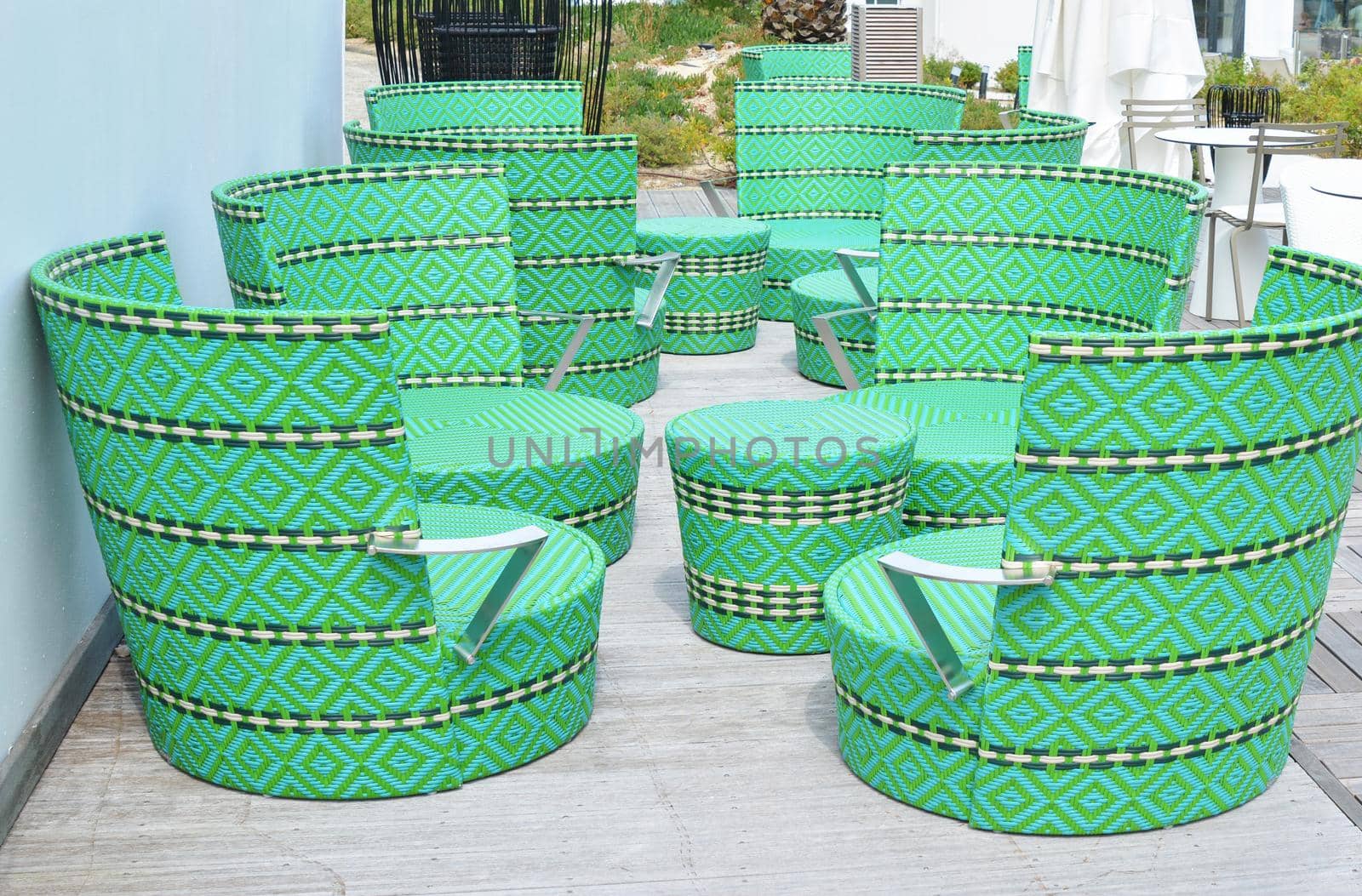 Comfortable green wicker chairs and table in a restaurant