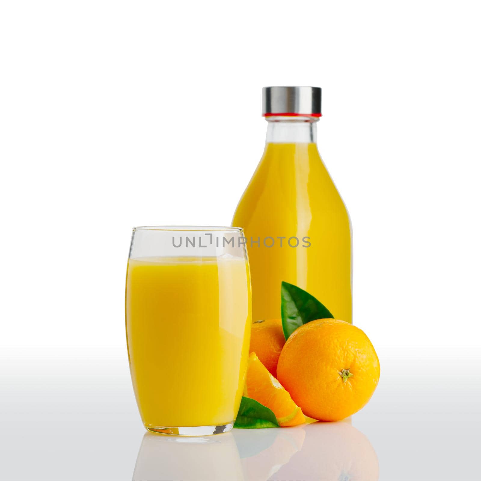 Glass of orange juice and orange juice bottle. Fresh tropical juice. by PhotoTime
