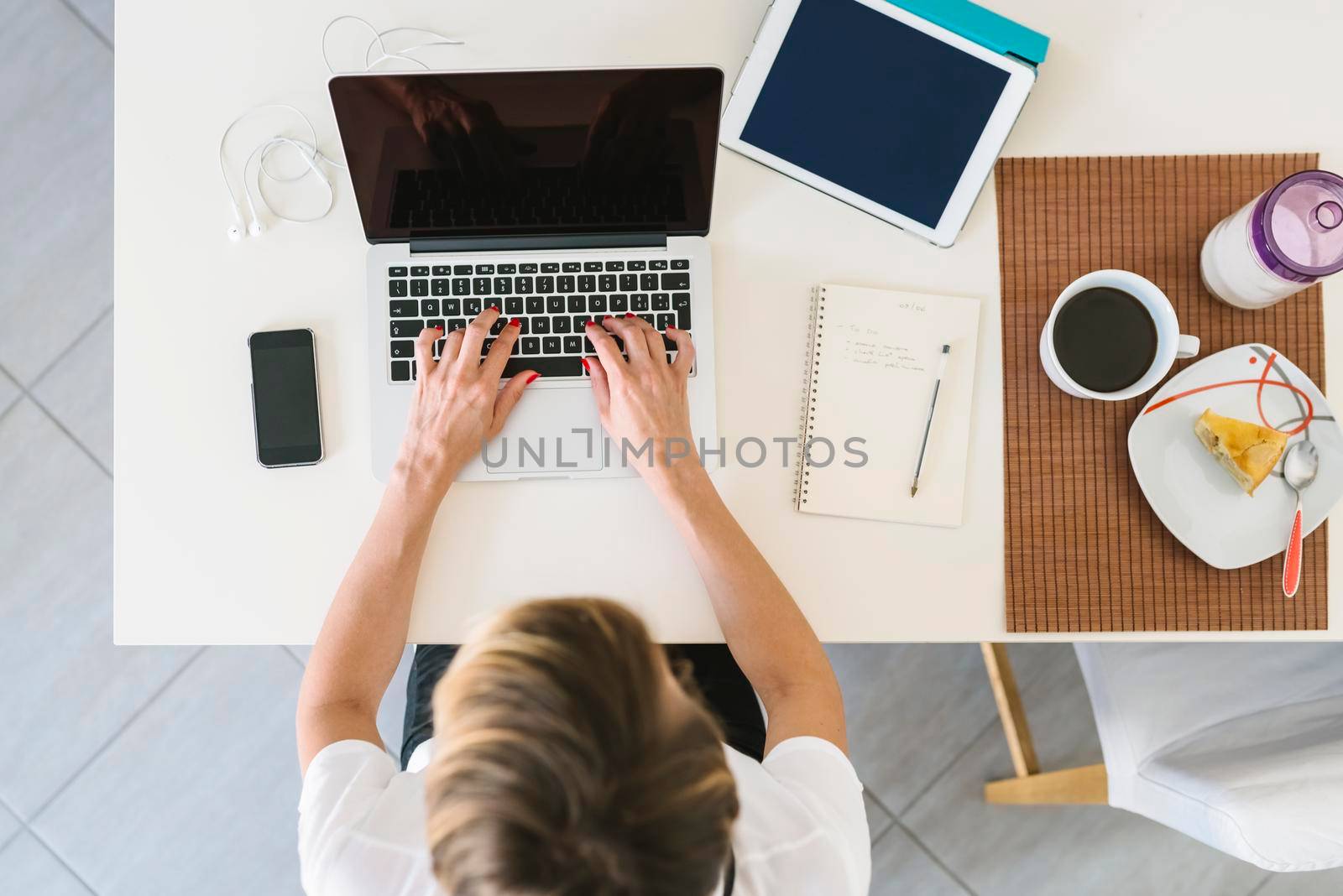 Businesswoman working from home using laptop.