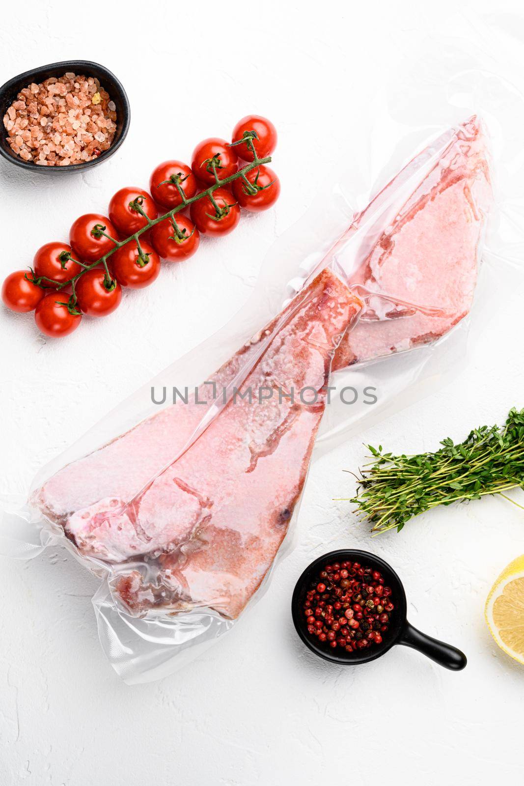 Ocean Perch fish meat frozen pack set, with herbs, on white stone table background, top view flat lay