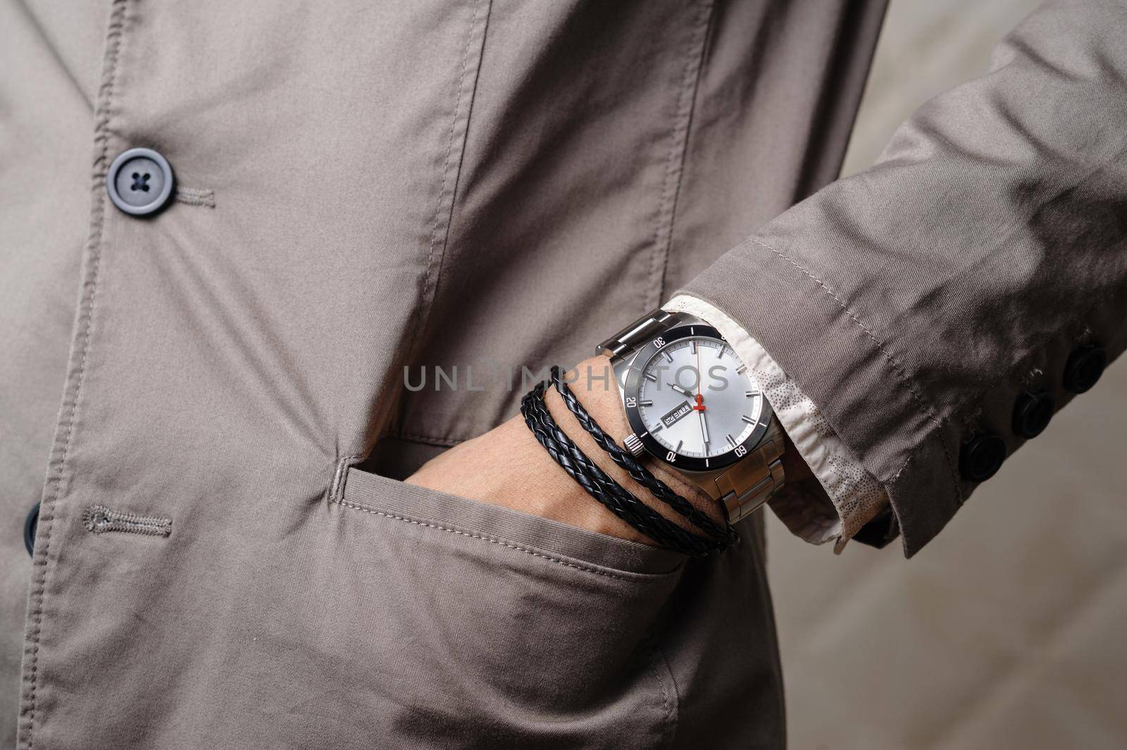 closeup the man's wrist wearing bracelets and wristwatch, casual style of men accessories.