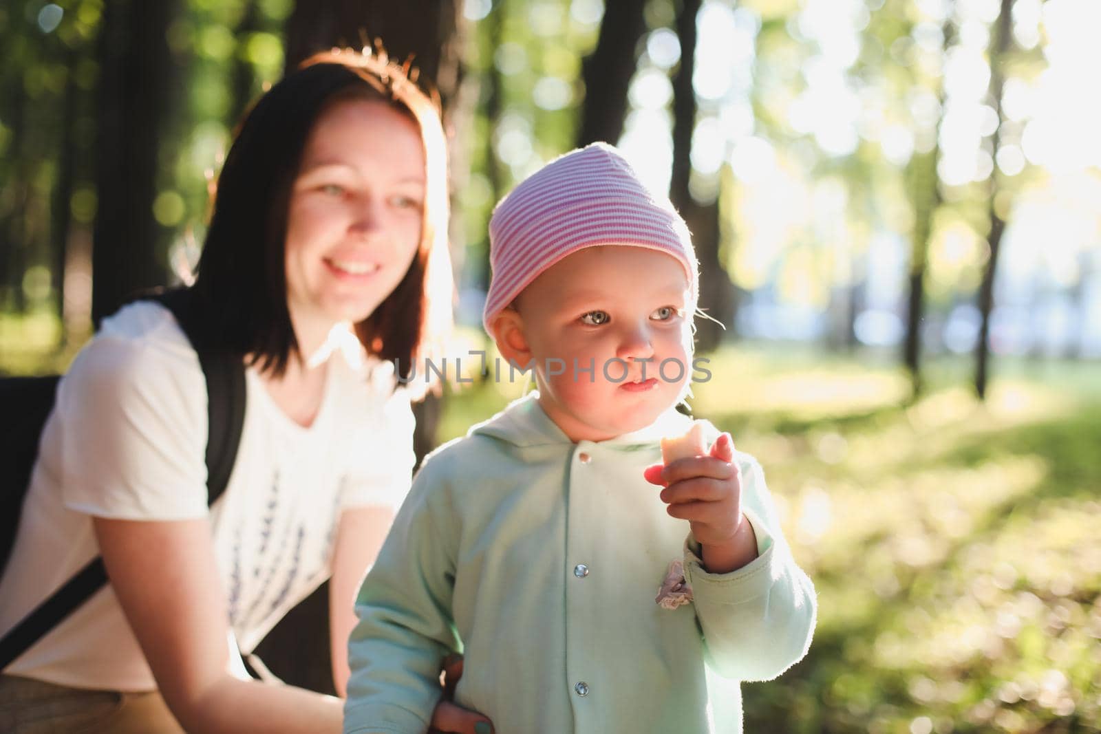 Mother and daughter in the park and enjoying nature. Happy family on summer walk