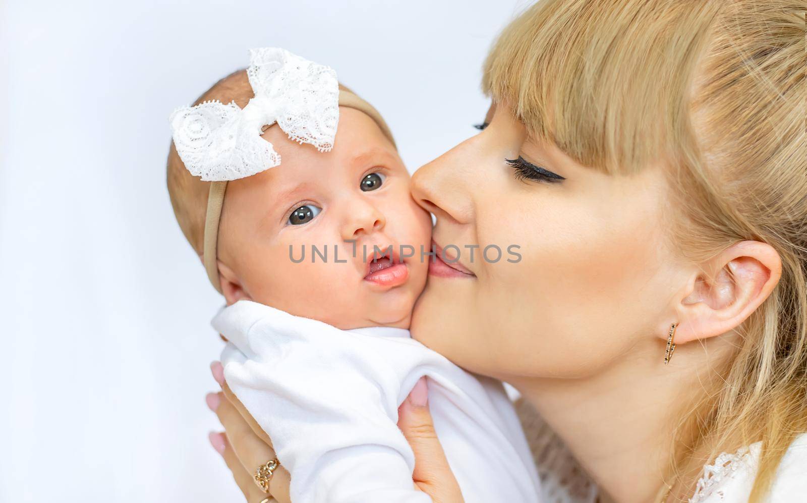 Mom is holding a newborn baby. Selective focus. People.