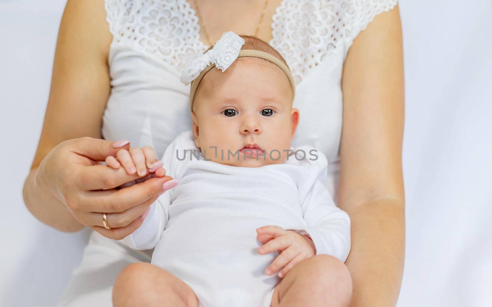 Mom is holding a newborn baby. Selective focus. People.