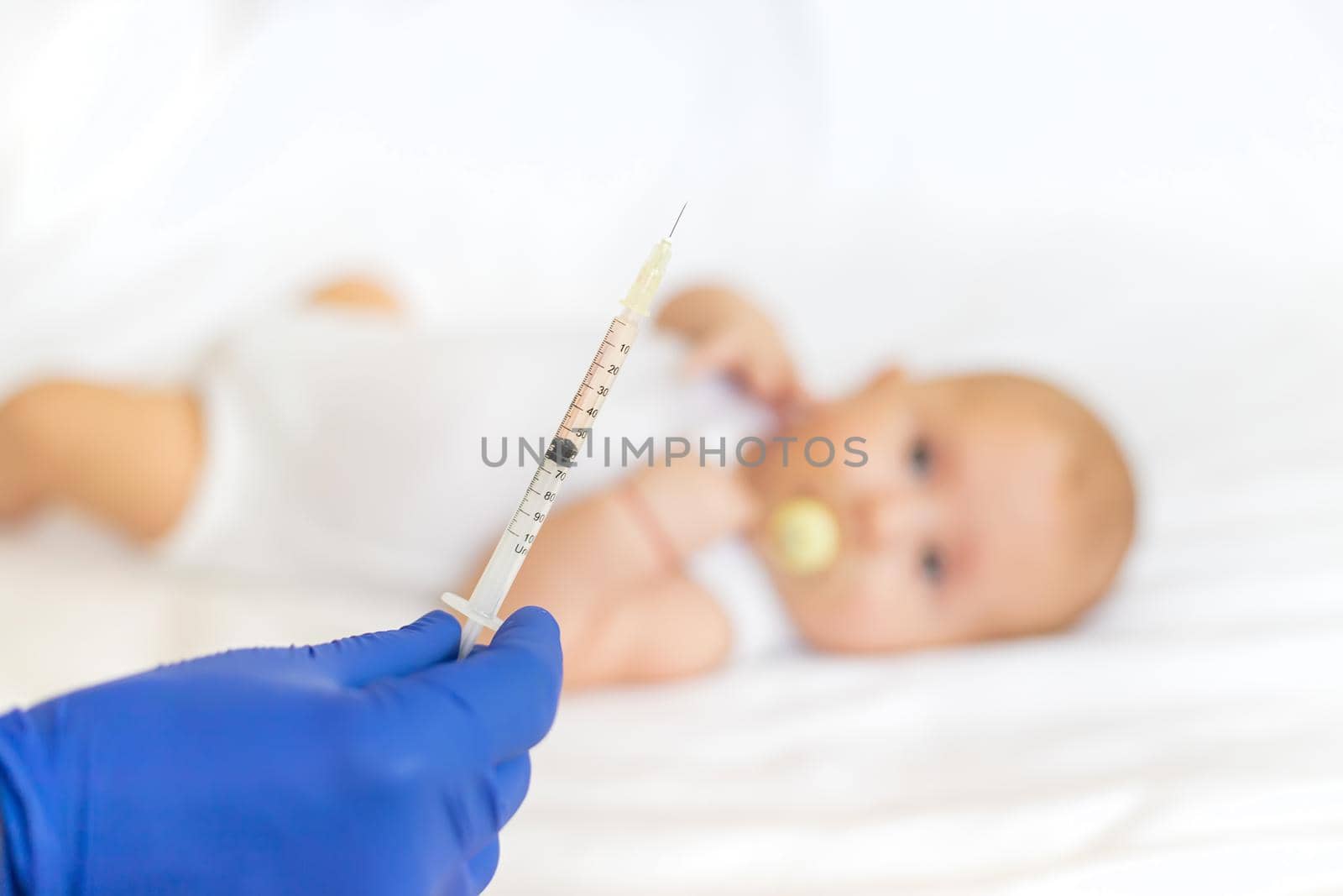 Vaccination baby, injection in the arm. Selective focus. People.