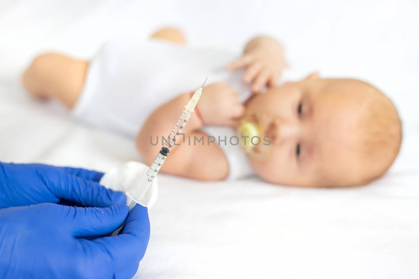 Vaccination baby, injection in the arm. Selective focus. People.