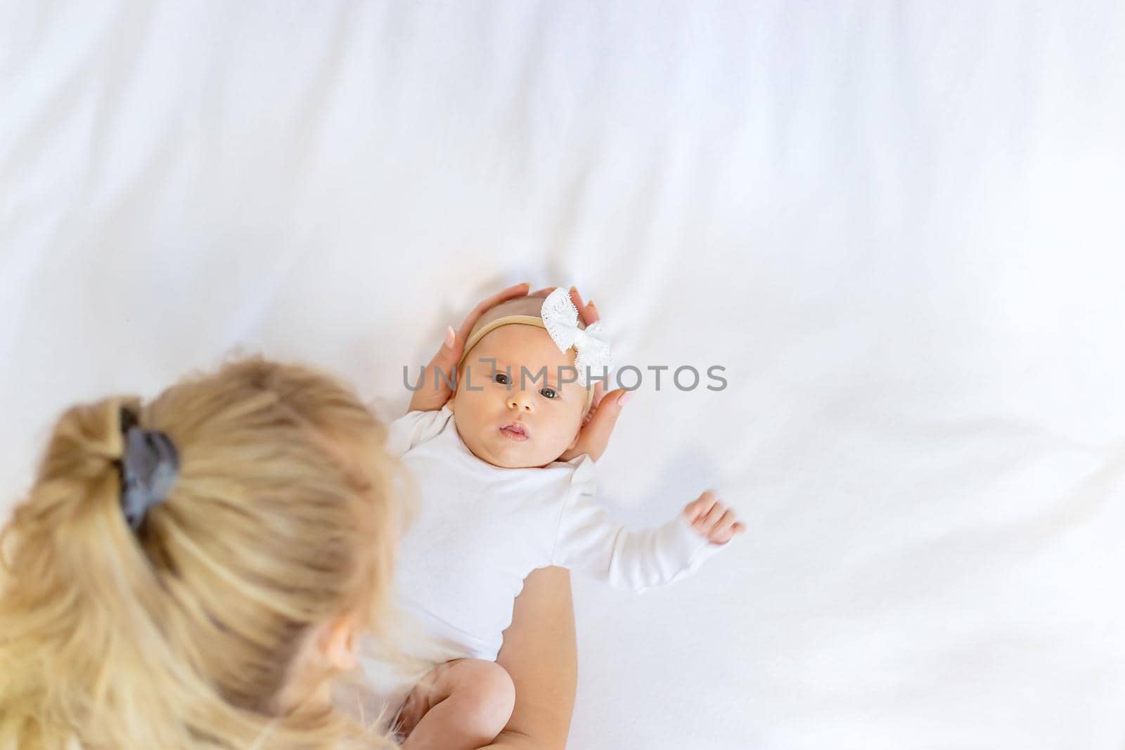 Mom is holding a newborn baby. Selective focus. People.