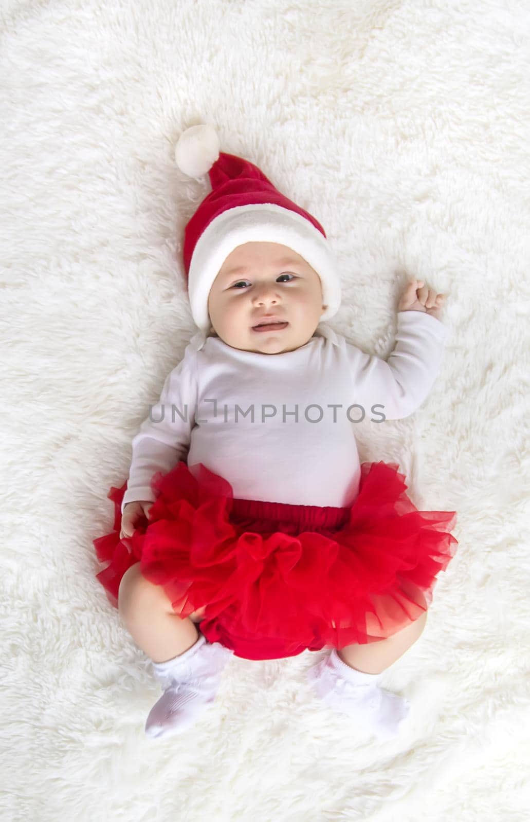 Baby dressed as Santa Claus. Christmas. Selective focus. People.