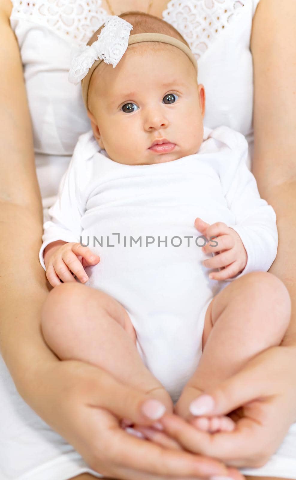 Mom is holding a newborn baby. Selective focus. People.