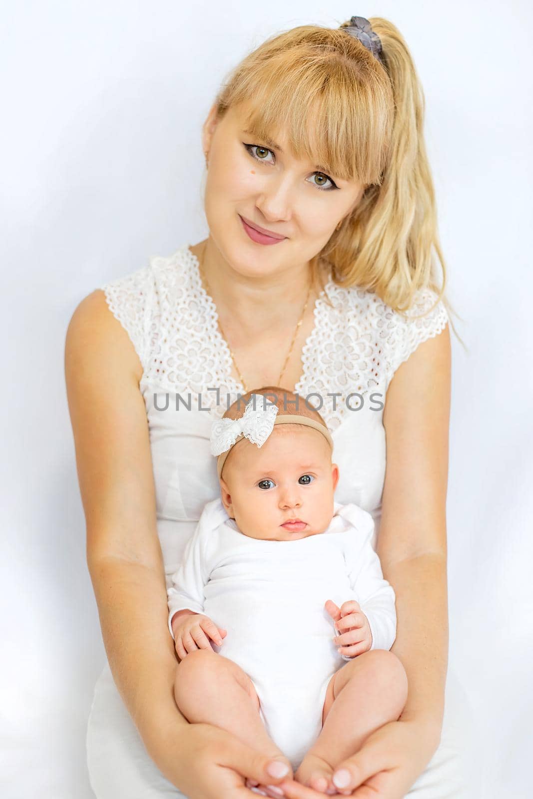 Mom is holding a newborn baby. Selective focus. People.