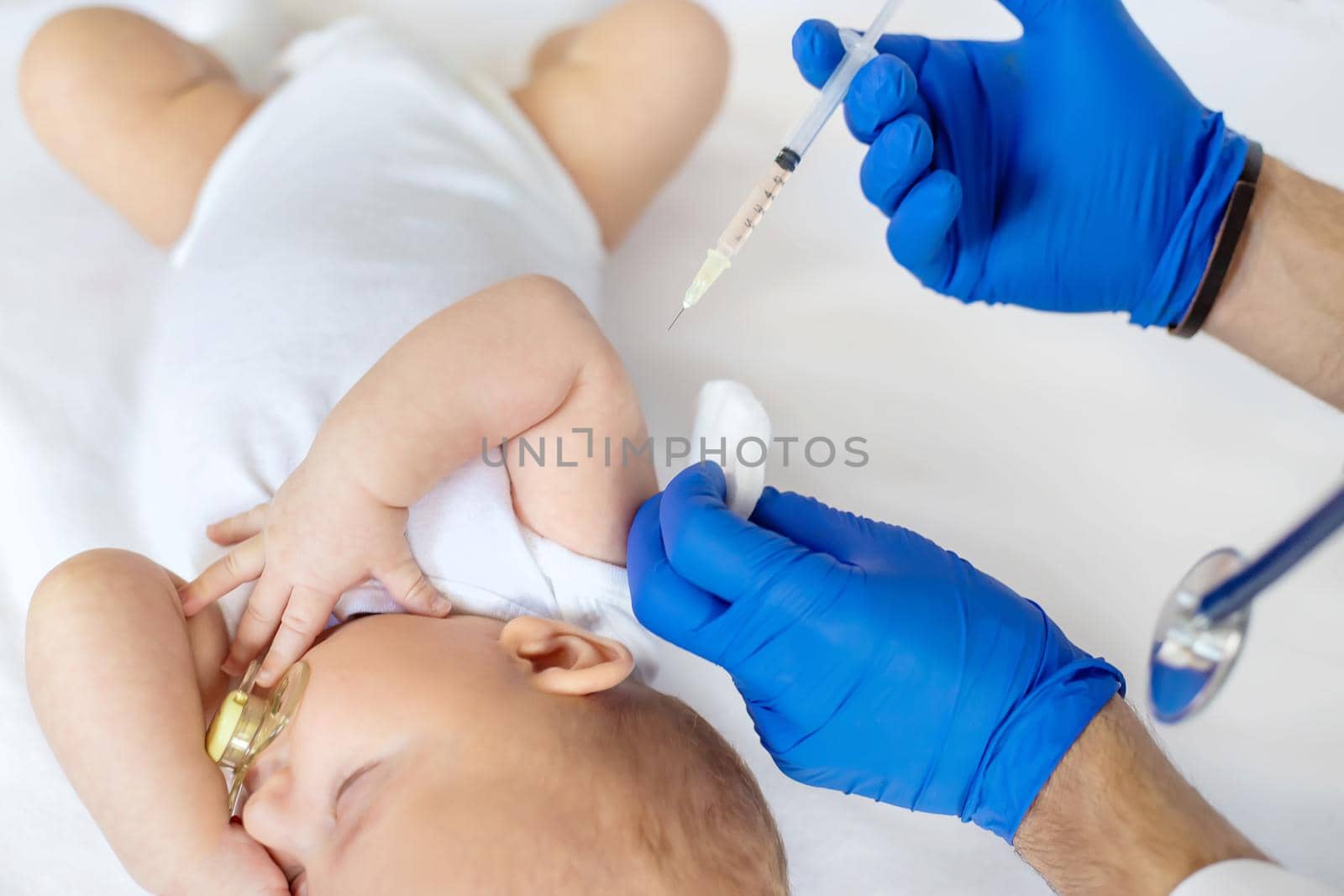 Vaccination baby, injection in the arm. Selective focus. People.
