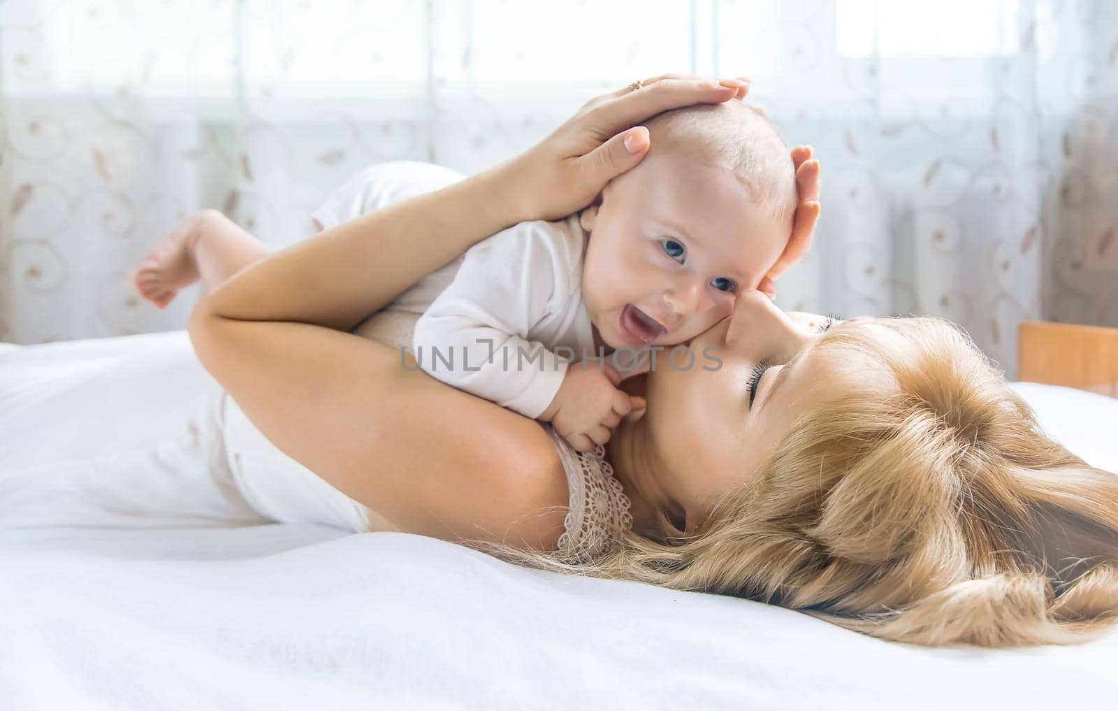 Mother with baby on a light background. Selective focus. People.