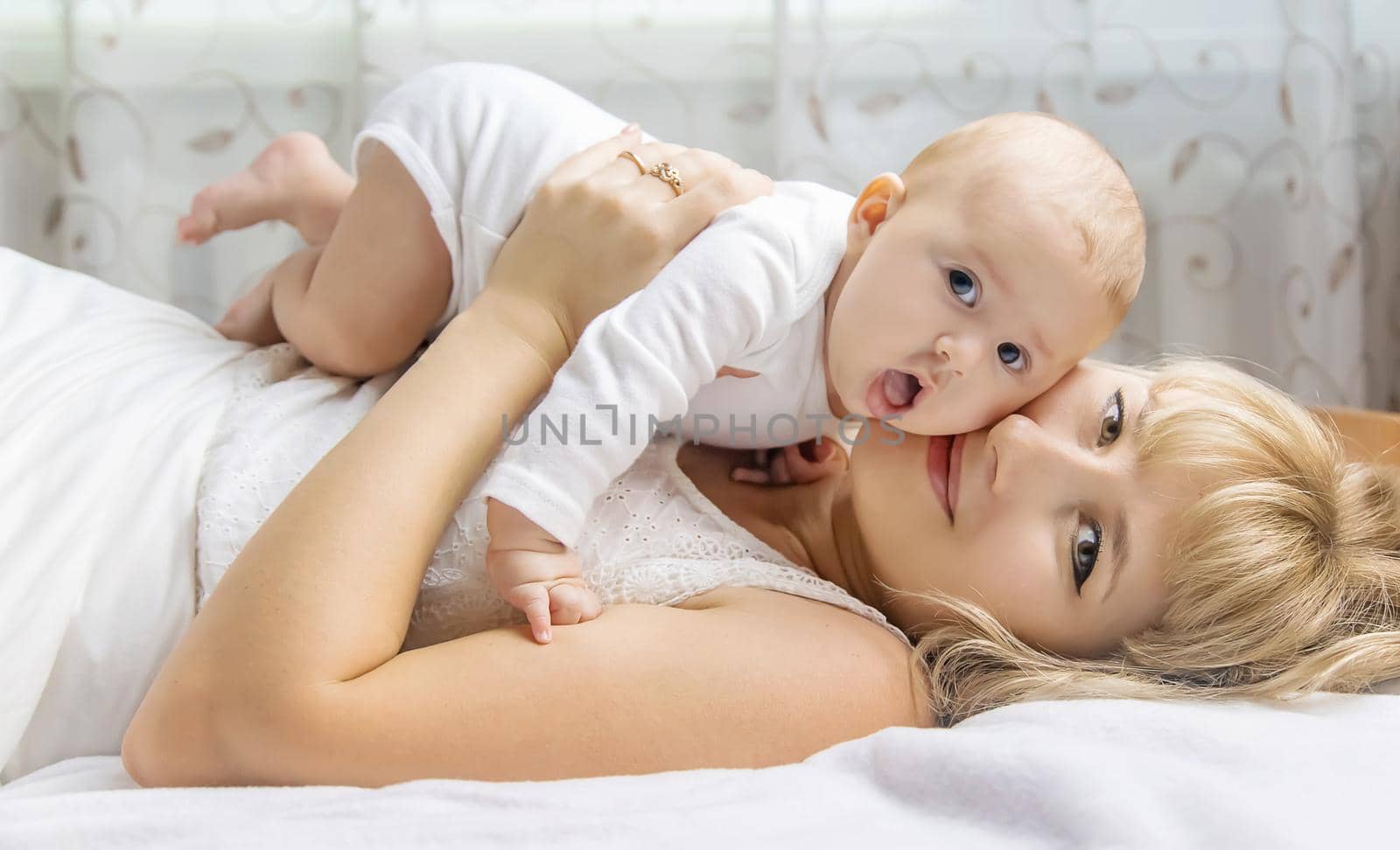 Mother with baby on a light background. Selective focus. People.