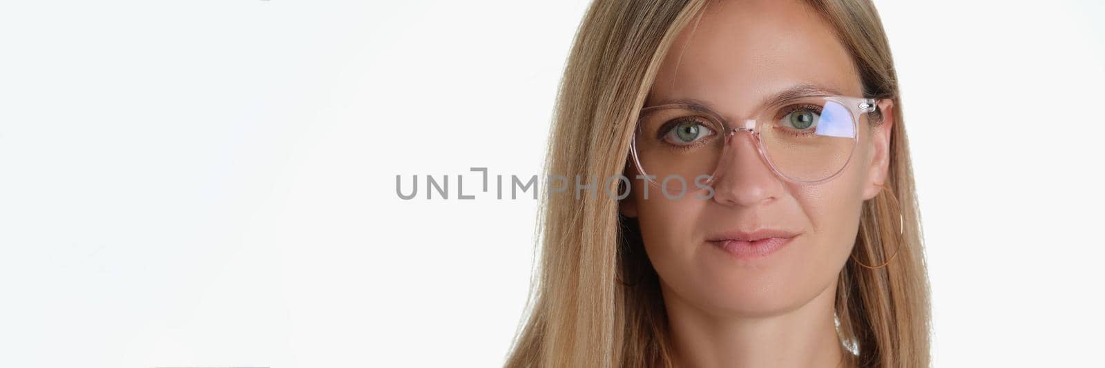 Portrait of beautiful blonde middle aged woman wearing glasses for better vision. Attractive female try on new model of frame. Ophthalmology, sight concept