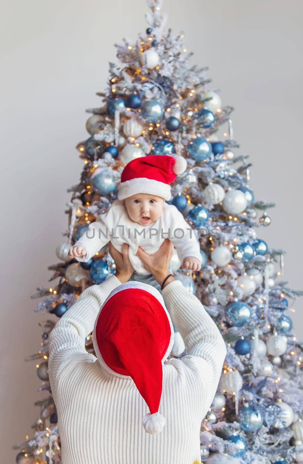 Christmas photo of a dad with a baby. Selective focus. Holiday.